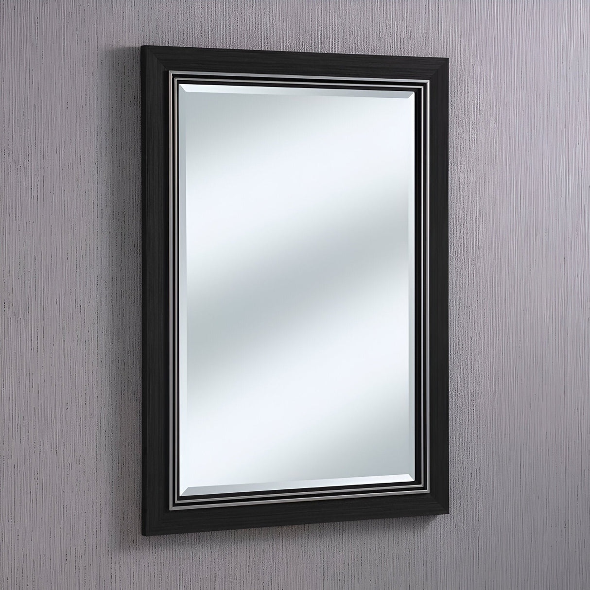 An Alaris Rectangle Wall Mirror - Black is mounted on a textured gray wall. Its sleek and glossy black wooden frame beautifully complements the minimalist decor of modern interiors. The mirror's clear reflection captures every subtle nuance of the textured surface behind it.