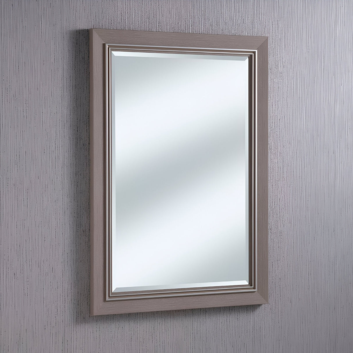 The Alaris Rectangle Wall Mirror - Grey, showcasing its minimalist aesthetic, includes a grey wood frame that offers a stunning contrast against the textured gray wall. Its reflective surface enhances the depth and dimension of the monochrome setting, bringing an elegant harmony to the room.