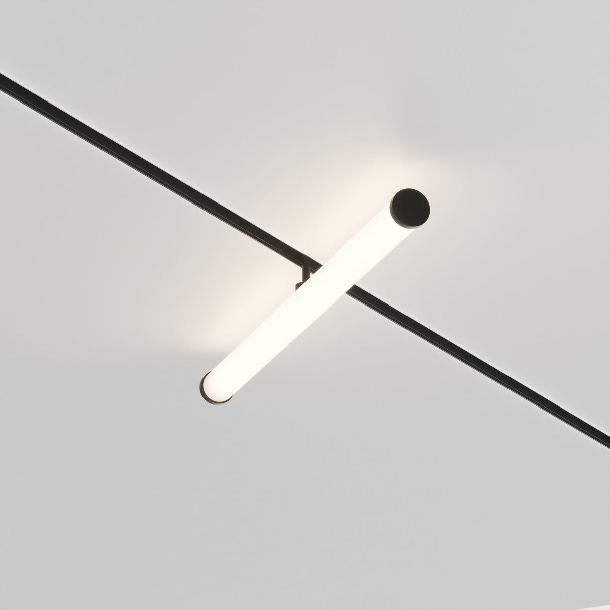 The Larc LED Rotating Linear Track Light for Magnetic Exility, featuring a sleek black rod and energy-efficient 25W 4000K LEDs, is mounted on the ceiling. It emits a soft white glow, enhancing the modern elegance against the plain light gray backdrop.