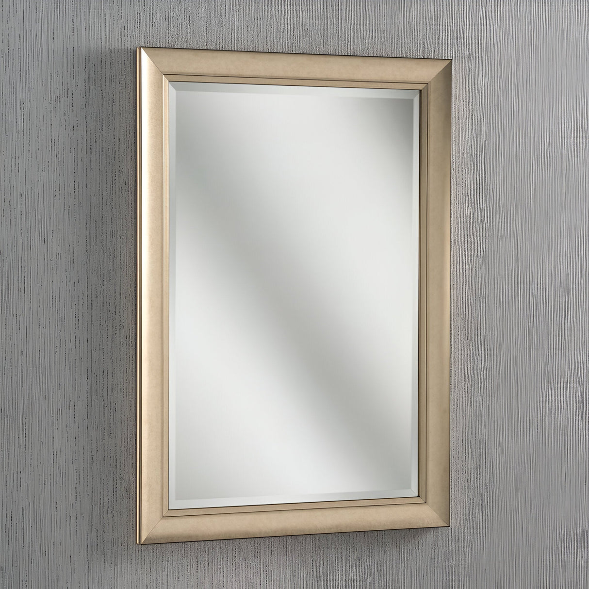 The Tivoli Rectangle Wall Mirror - Champagne, elegantly suspended on a textured gray wall, enhances the space with a touch of sophisticated interior style.