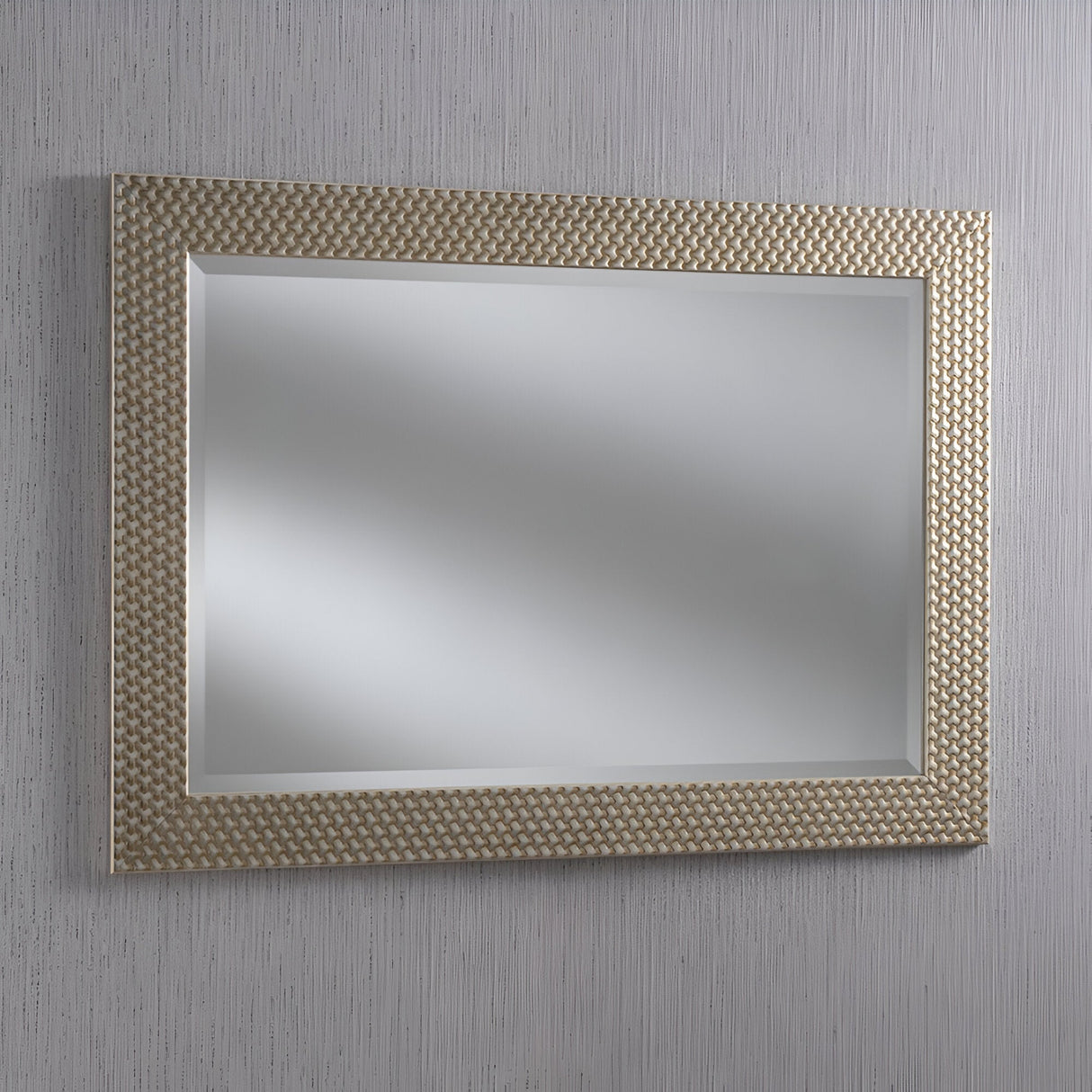 The Glimira Rectangle Wall Mirror - Champagne elegantly hangs on a gray, vertically striped wall, adding a sophisticated touch to the home decor. Its reflective surface captures a blurred, indistinct image.