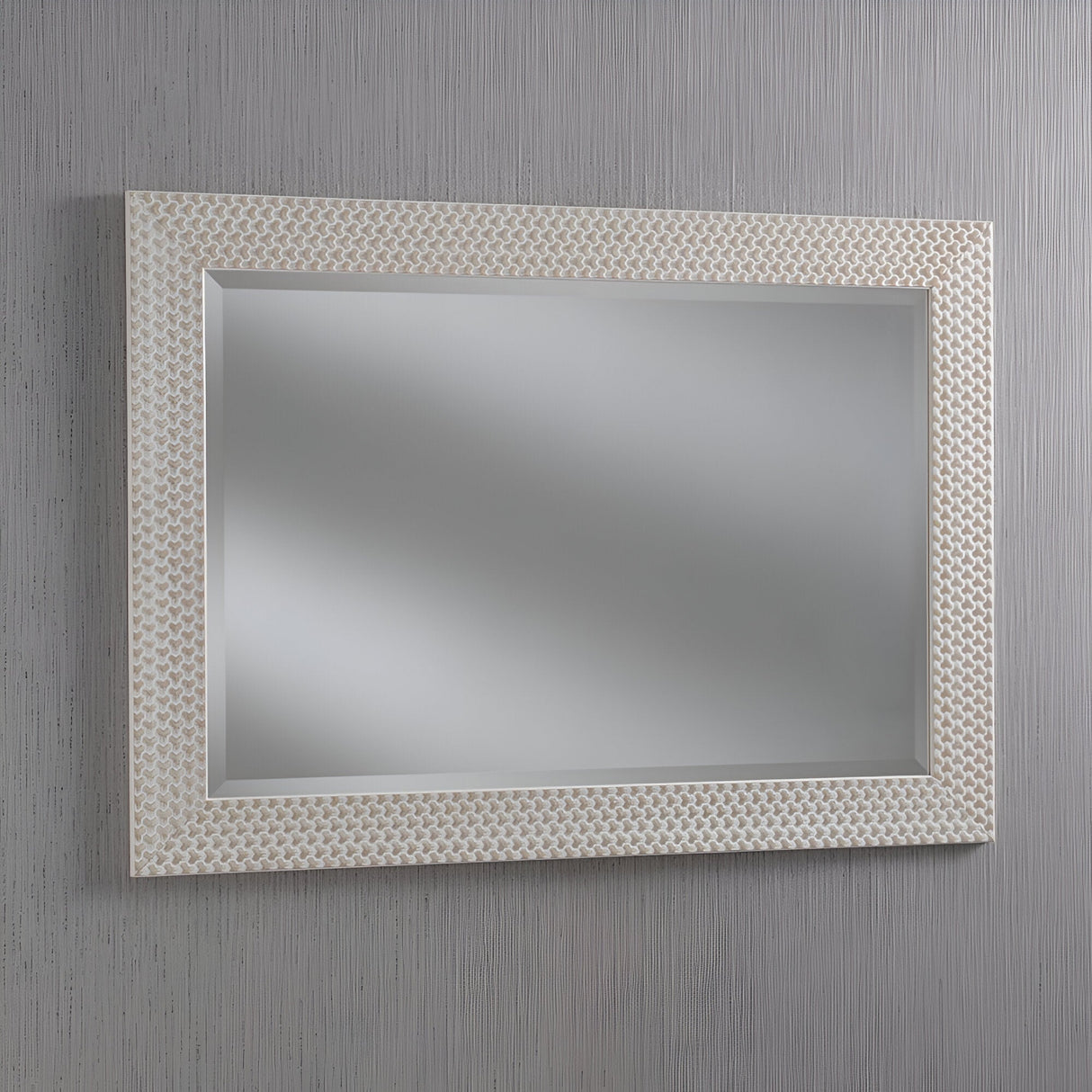 The Glimira Rectangle Wall Mirror - White, featuring a textured frame, hangs on a vertically striped gray wall, providing a modern aesthetic with its reflective surface.