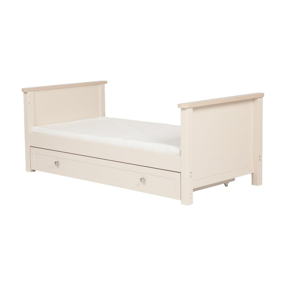 Wanderer Convertible Cot Bed with Drawer in Cashmere, cream finish with oak-effect trim, low panel ends, mattress included, and under-bed storage drawer with knob handles.