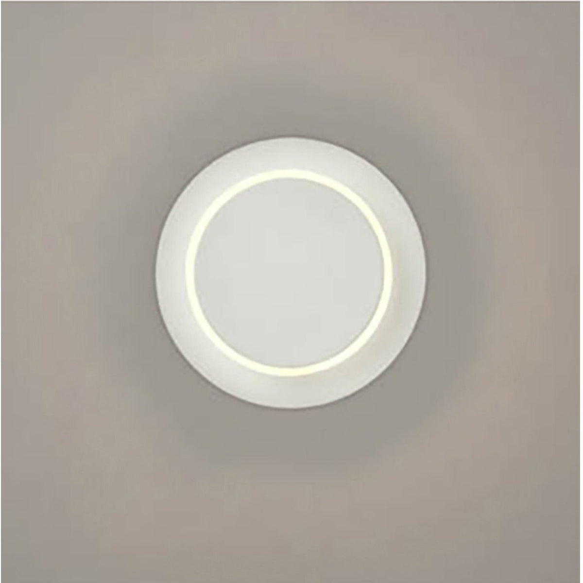 Crescent White LED Wall Light with a round matt white disc design and a soft glowing inner ring, mounted on a plain neutral wall.