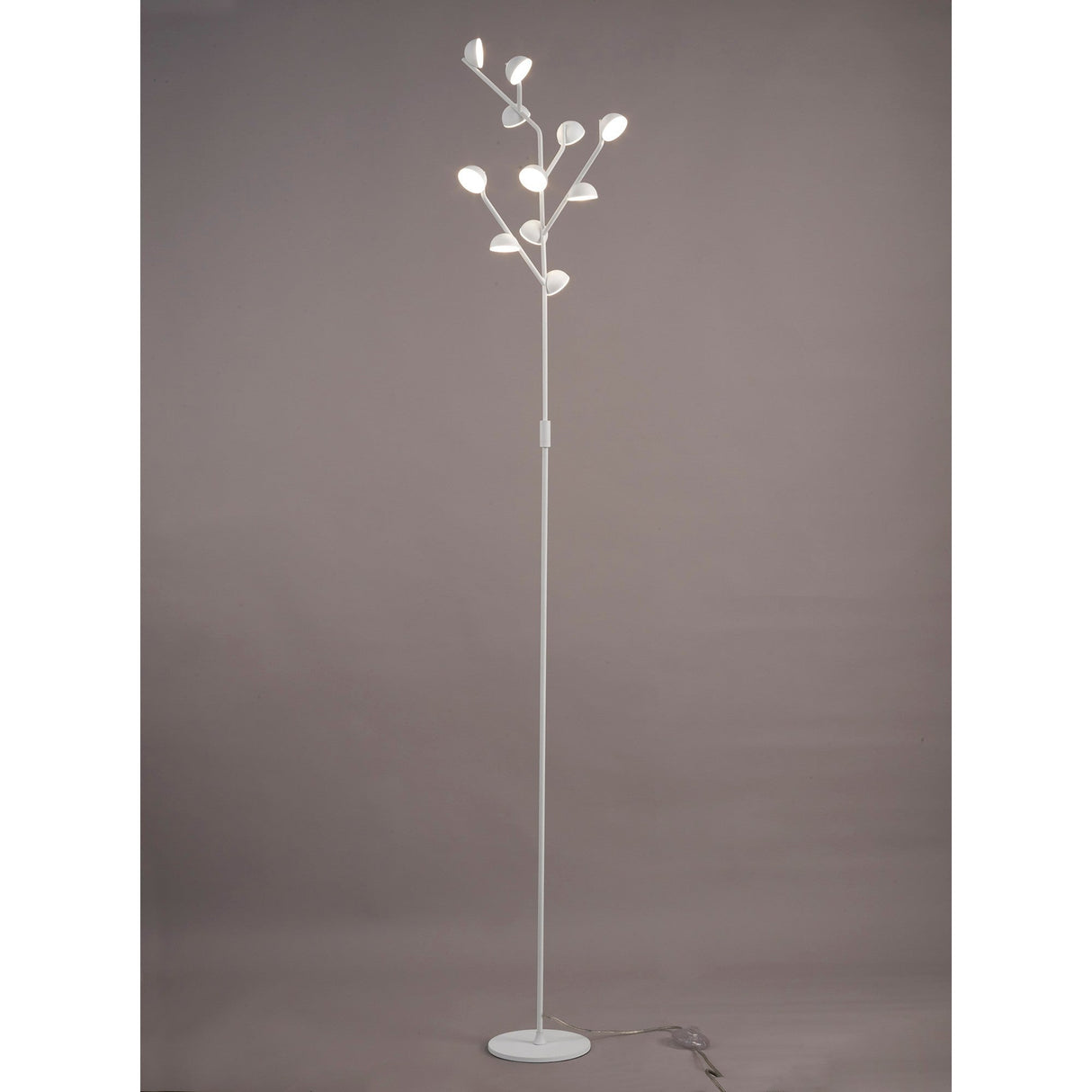 The Adn LED Floor Lamp 30W 3000K - White features a slim, modern design with multiple branches ending in glowing bulbs, creating sculptural ambient lighting that evokes plant-like forms against a simple gray backdrop.
