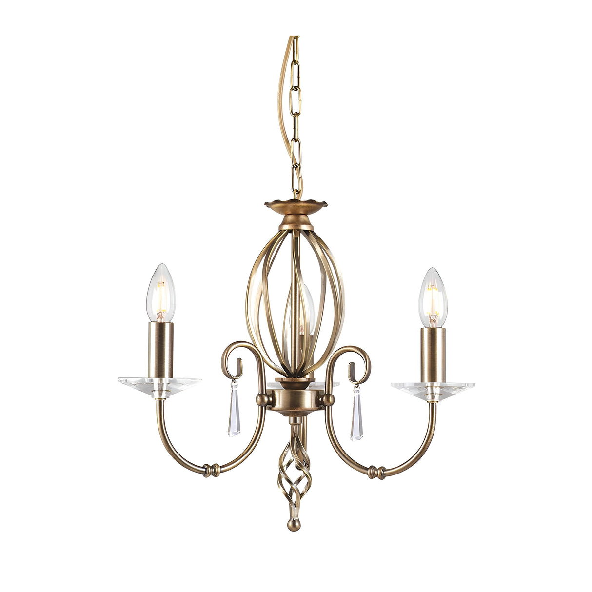 The Aegean 3 Light Chandelier - Aged Brass showcases timeless elegance with three candle-shaped bulbs perched on gracefully curved arms, finished in a classic aged brass. Its intricate central spiral design and hand-forged scrolls are beautifully accented by small glass ornaments, all suspended elegantly from a chain.