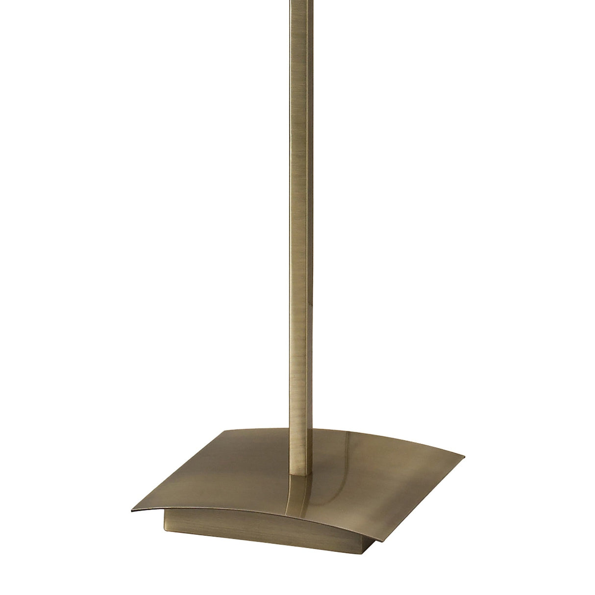 A close-up of the Akira 3 Light Floor Lamp’s metallic base reveals its sleek, slightly curved rectangular design and slender pole. The antique brass finish adds elegance, while the cream shade provides stylish ambient lighting.