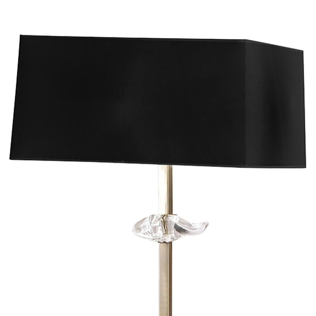 The Akira 3 Light Floor Lamp features an antique brass finish, a slim metallic stand, and a black fabric shade, with a decorative clear glass element shaped like a fish near the base of the shade.