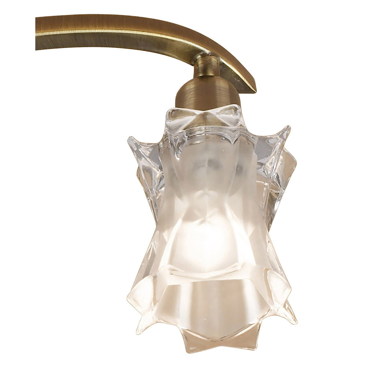 Close-up of one sculpted frosted and clear glass star-shaped shade on a curved antique brass arm from the Mantra Alaska 3 Light Semi-Flush Ceiling Light.