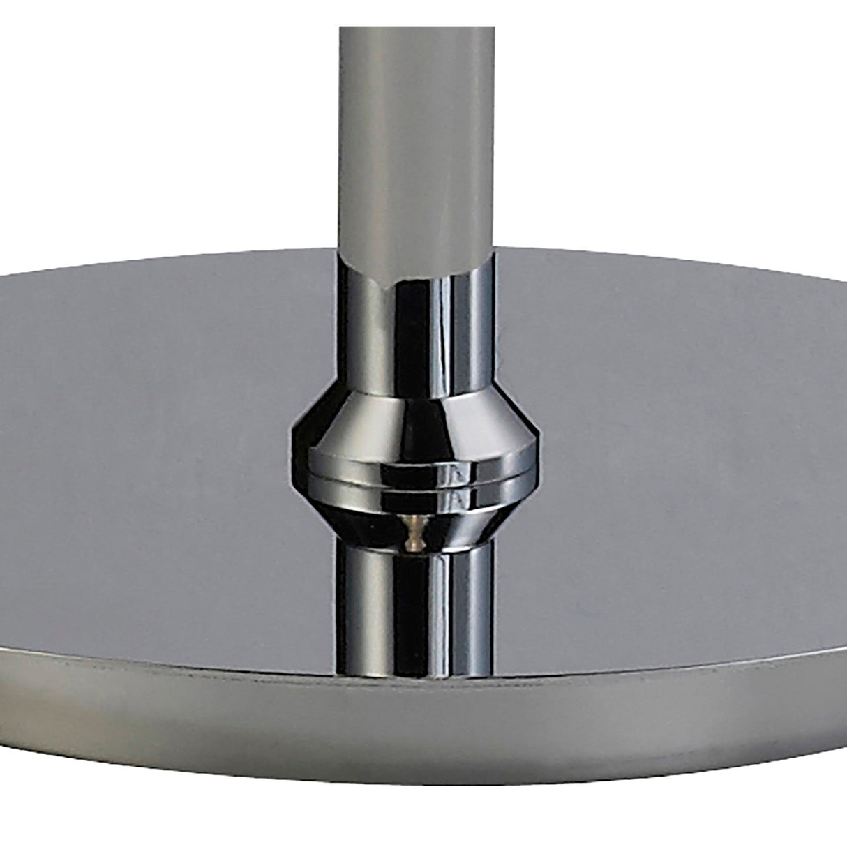 Close-up of the Alexandra 6 Light Crystal Floor Lamp’s polished chrome circular base with a centered vertical rod, its smooth surface reflecting ambient lighting and nearby objects.