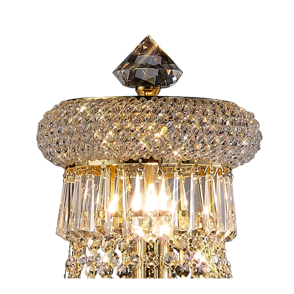 Close-up of the Alexandra 6 Light Crystal Floor Lamp in gold, featuring a round gem-like crown and hanging rectangular prisms, radiating bright light—perfect for adding luxury with elegant crystal accents against a white background.