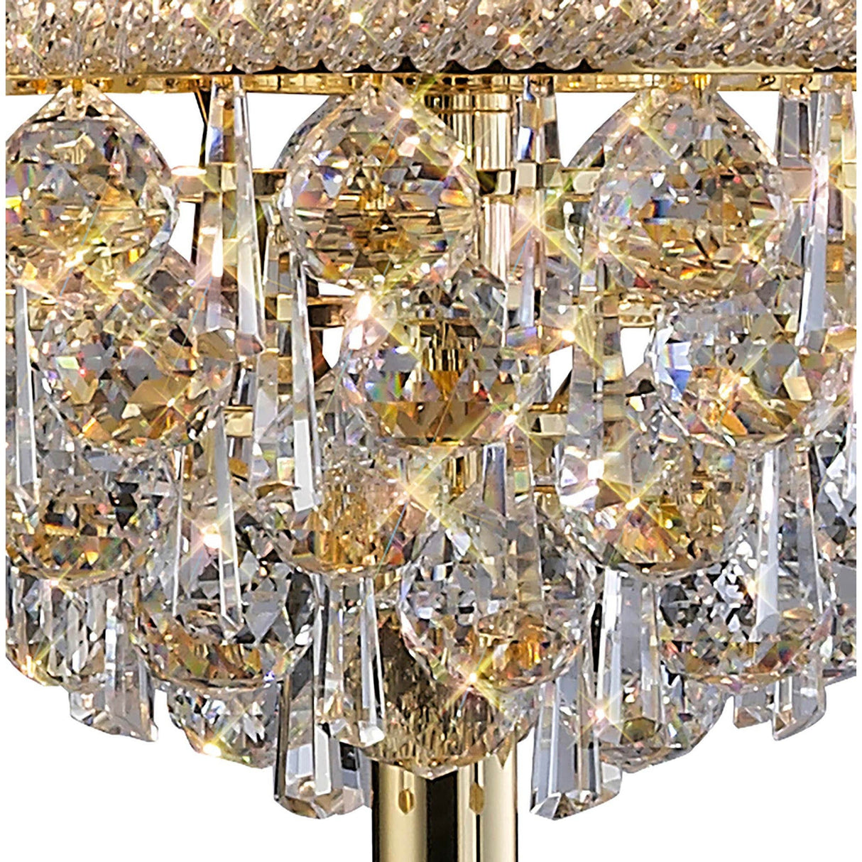 Close-up of the Alexandra 6 Light Crystal Floor Lamp in gold, featuring faceted diamond and teardrop crystals on a gold base that reflect light to create a sparkling effect.