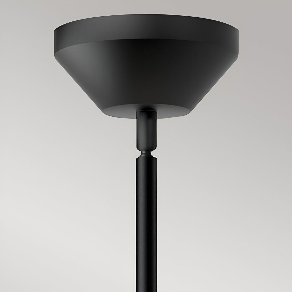 Close-up of the Alora Mood Halston pendant's matte black canopy and slim stem against a light grey background.