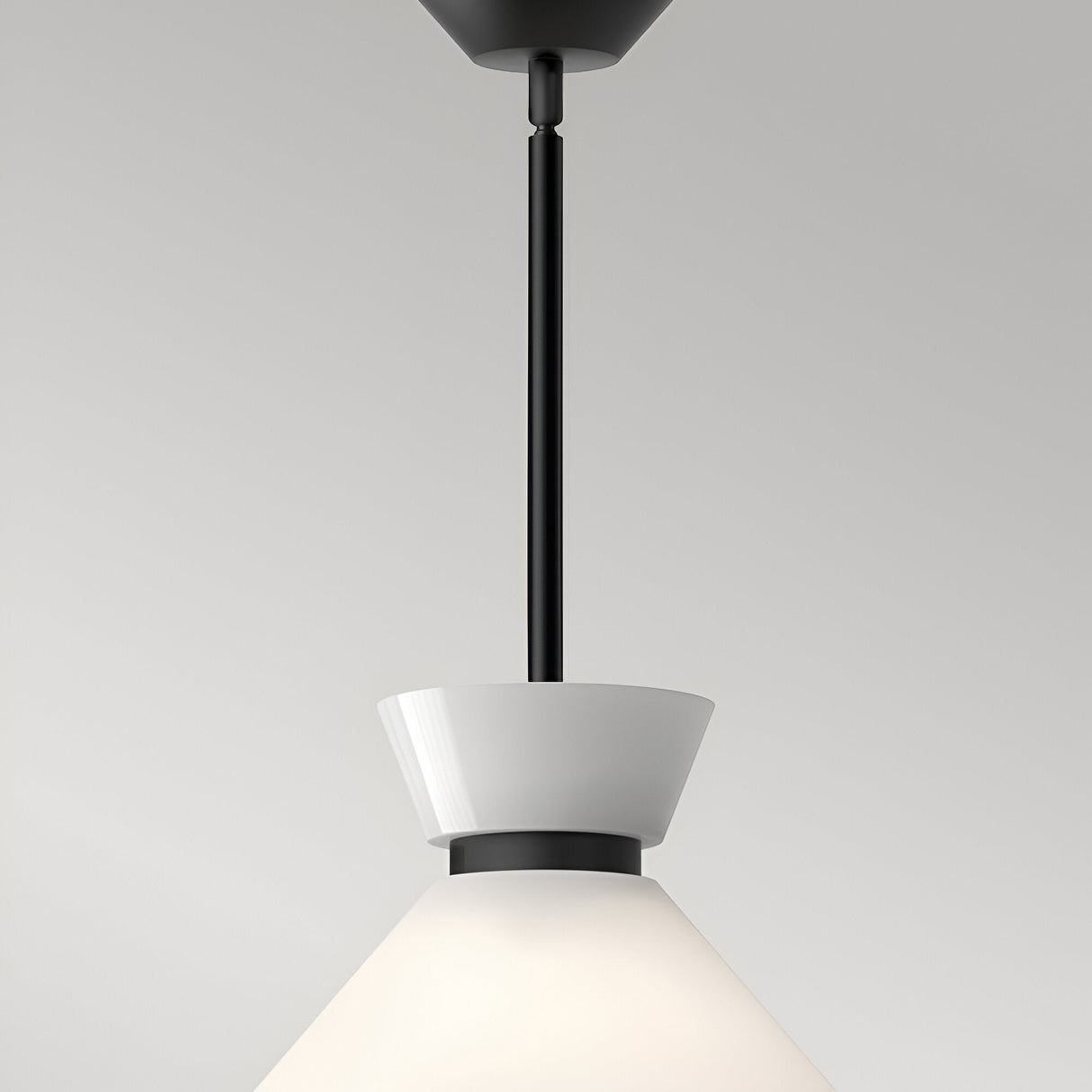 Alora Mood Halston 1 Light Glass Pendant in matte black, close-up of the canopy, slim rod stem and white opal glass cone collar against a light background.