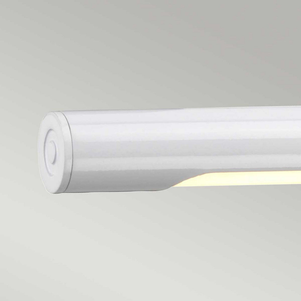 The Alton 1 Light Large LED Picture Light in white offers a sleek, cylindrical design that emits a soft, warm glow with energy-efficient LED technology, elegantly mounted horizontally against a light gray background.