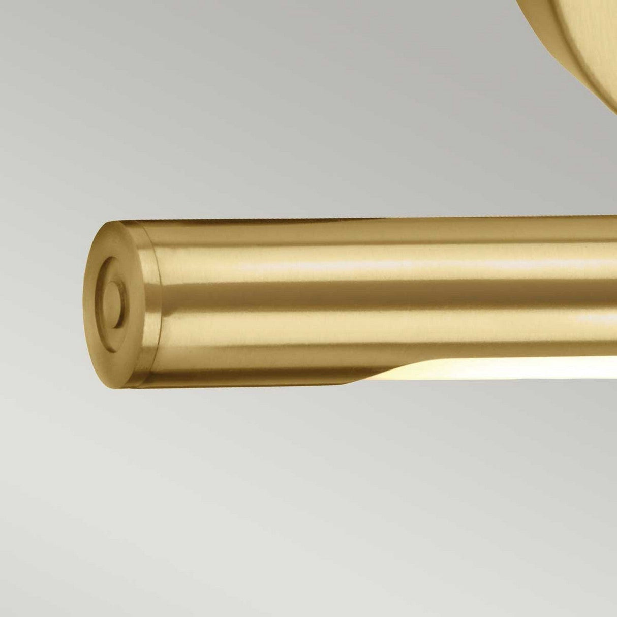 A close-up of the Alton 1 Light Small LED Picture Light in brushed brass, featuring its sleek, cylindrical design with a smooth finish. Mounted horizontally against a neutral background, this fixture is ideal for illuminating artwork and highlights its end cap design and subtle metallic sheen.