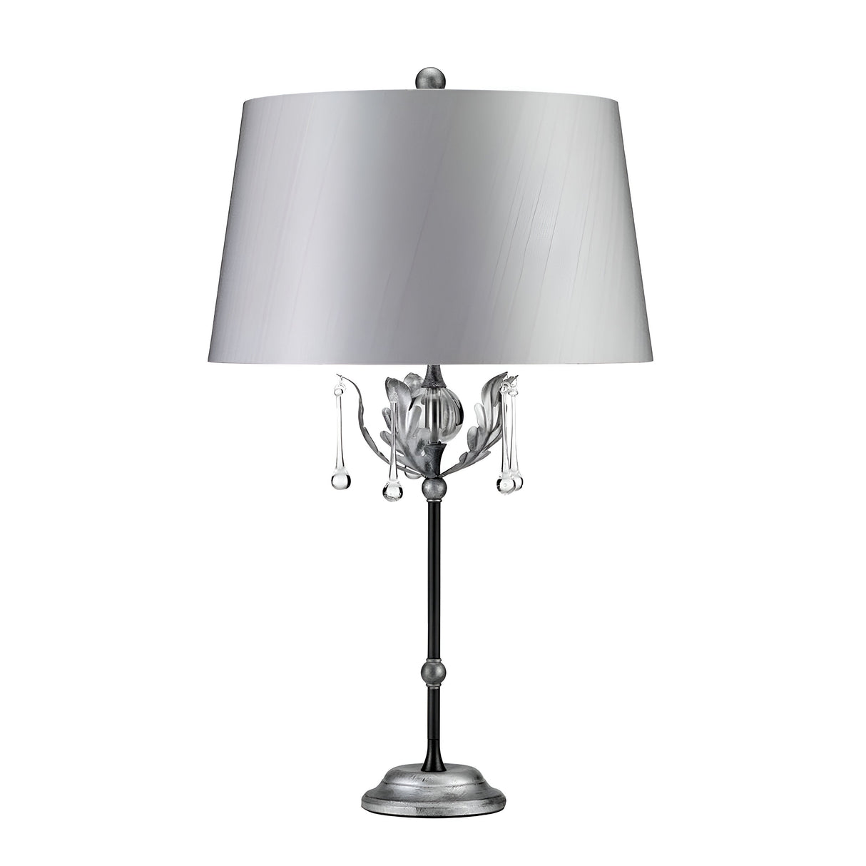 The Amarilli 1 Light Table Lamp in Black with Silver Patina serves as a decorative statement piece, featuring a sleek gray shade. Its base boasts handcrafted detailing and an ornate metal design, enhanced by hanging crystal-like elements that add an elegant touch to its overall appearance.