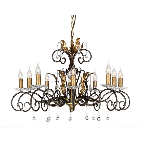 The Amarilli 10 Light Chandelier - Bronze With Gold Patina is a luxurious lighting fixture featuring ten candle-shaped lights. Its intricate bronze scrollwork with gold patina and clear crystal pendants hanging below create an opulent ambiance.