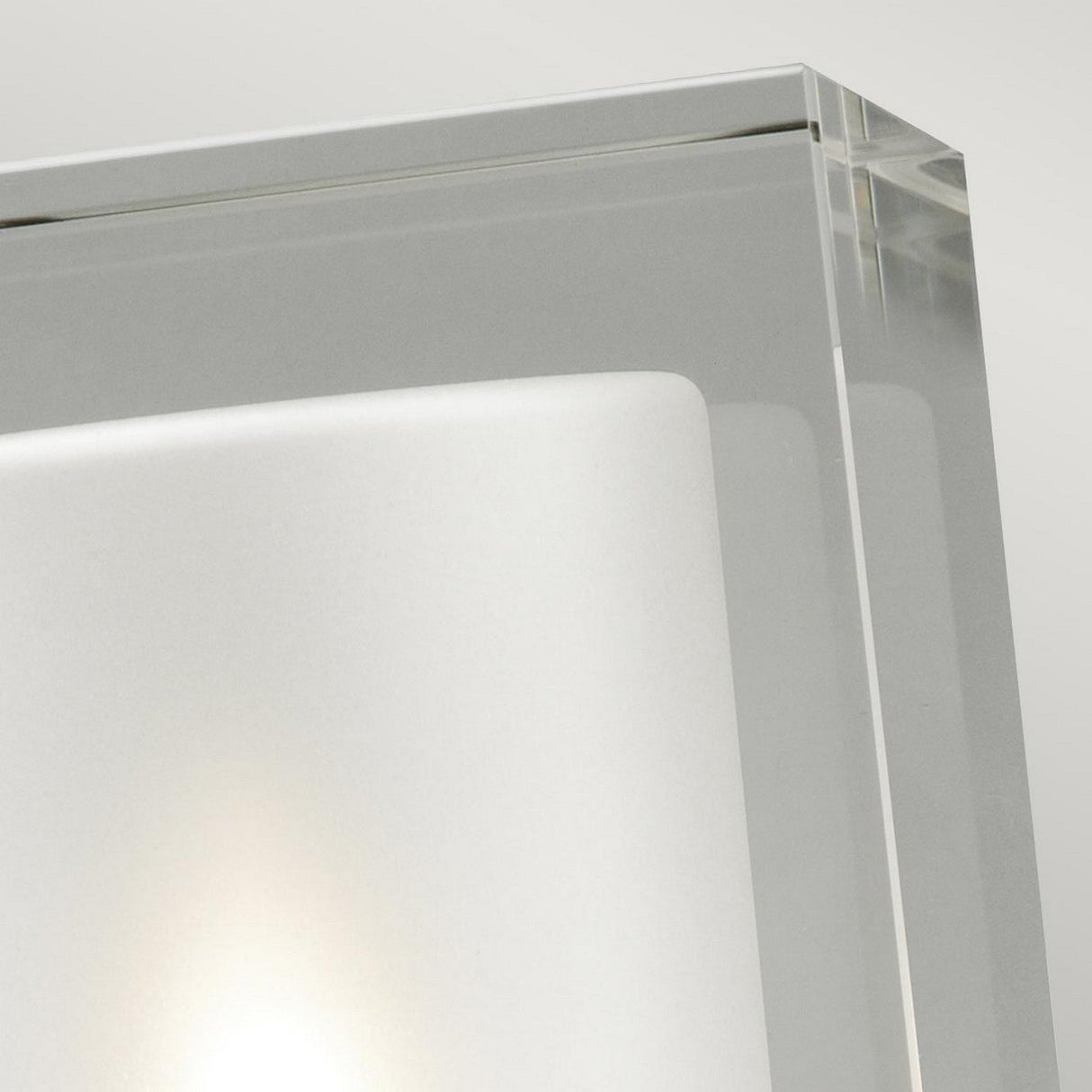 Detailed view of the Arendal Outdoor 1 Light Wall Light in black, boasting an IP65 rating. This fixture features a frosted glass square housed within a clear glass frame. Its black powder-coated finish accentuates the minimalist and clean design, beautifully contrasted against a light gray background for a modern and sleek aesthetic.