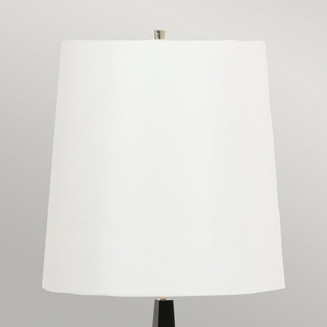 The Ascent Floor Lamp With White Shade - Black is displayed against a neutral background, showcasing its simple cylindrical design. This lamp blends modern functionality with elegance, making it a perfect decorative piece for any room.
