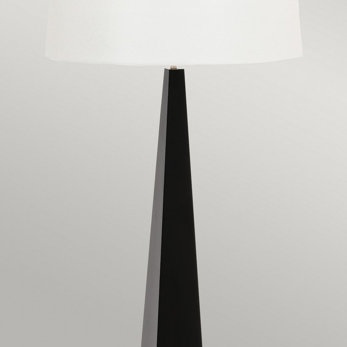 The Ascent Floor Lamp With White Shade - Black is a decorative piece featuring modern functionality, boasting a tall and sleek black base accompanied by a large white lampshade set against a light gray background.