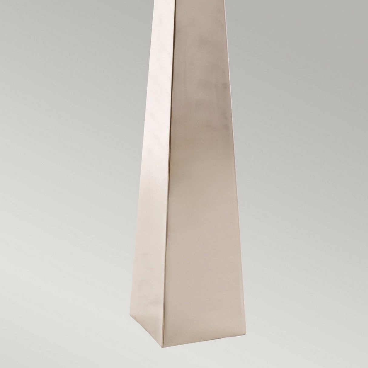 Presenting the Ascent Floor Lamp With Black Shade, boasting a sleek and tapered metallic design in a polished nickel finish. It stands out beautifully against a light gray background, with its smooth surface offering a subtle reflective sheen.