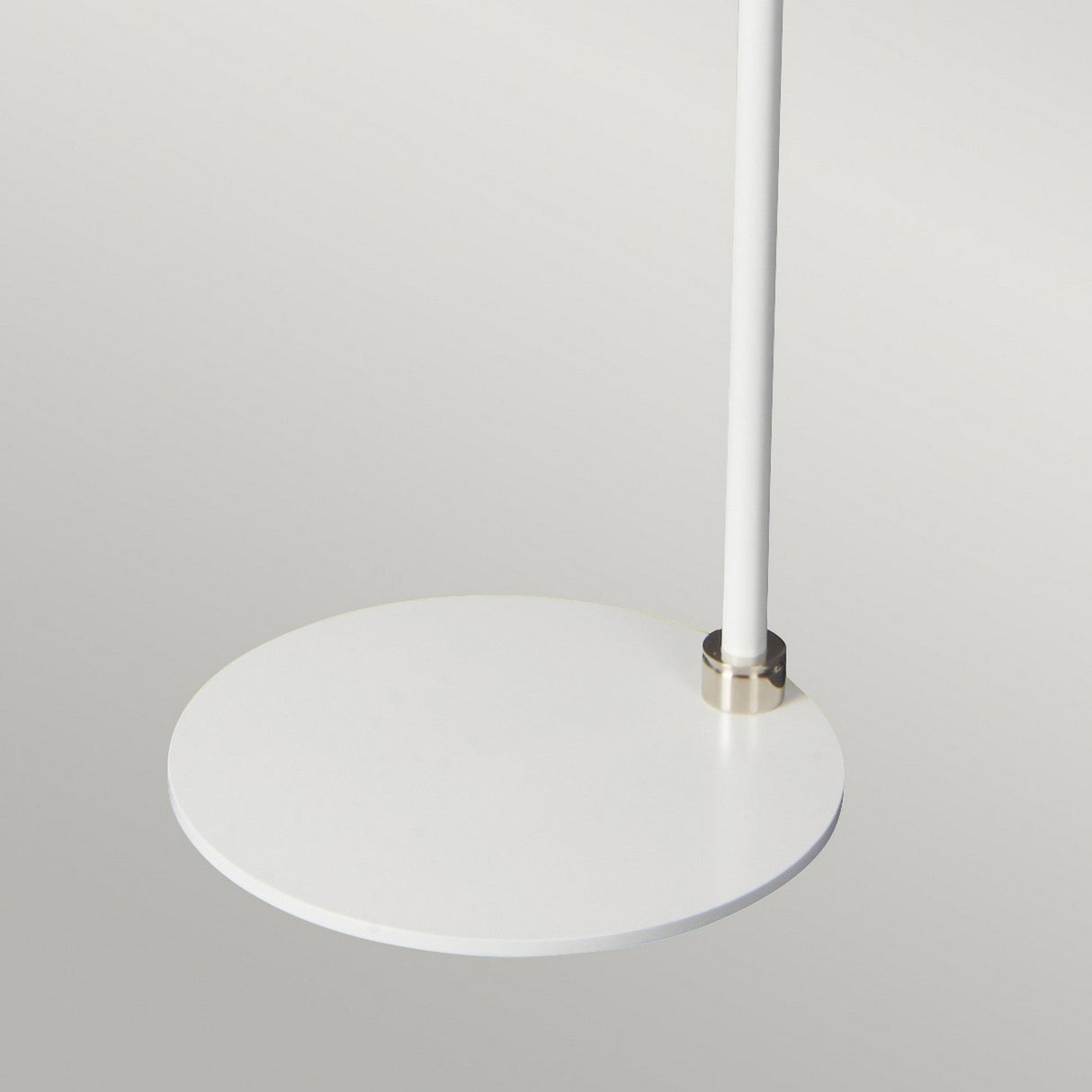 Close-up view of the Balance Floor Lamp in white with a polished nickel accent, featuring a minimalist round shelf attached to a sleek vertical pole, reminiscent of modern floor lamp design.