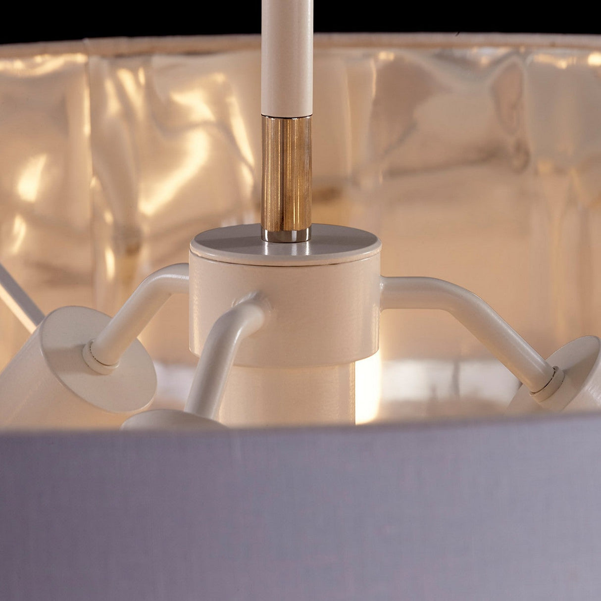 A close-up view of the interior of the Balance Pendant Light - White/Polished Nickel reveals a fixture with multiple arms supporting individual bulbs. Its reflective metallic interior enhances its contemporary lighting style and provides energy-efficient illumination.