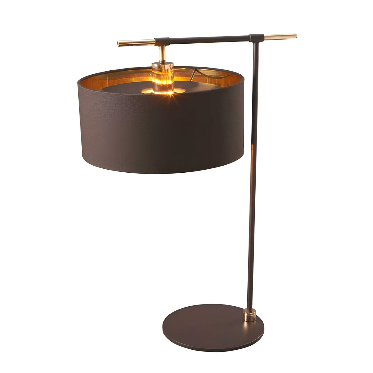 The Balance Table Lamp - Brown/Polished Brass features a cylindrical black shade and a sleek, minimalist metal stand adorned with polished brass accents. Its energy-efficient design emits a warm, soft glow from an exposed bulb, enhancing the lamp's elegant and contemporary aesthetic.