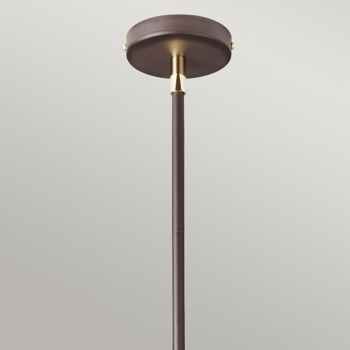 Introducing the Balance 5 Light Chandelier - Brown/Polished Brass: a minimalist ceiling-mounted fixture featuring a dark brown cylindrical base and slim rod with polished brass accents, perfect for adding an elegant touch in energy-efficient lighting against a neutral background.