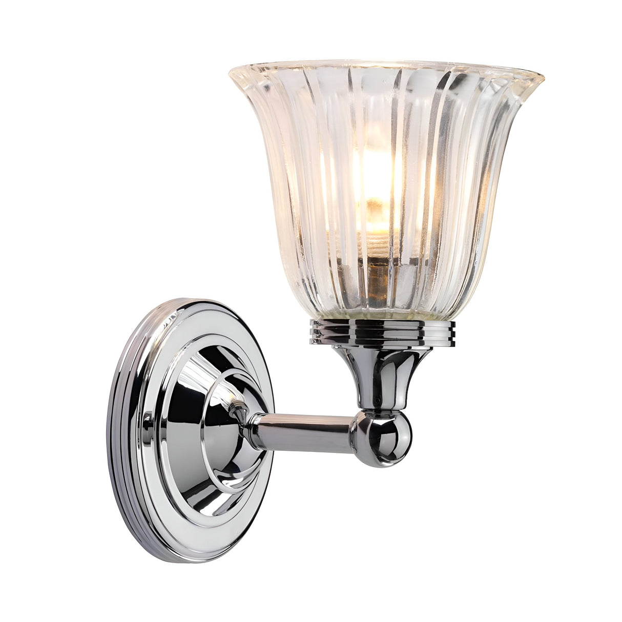 The Austen-1 Wall Light - Polished Chrome showcases a polished chrome base paired with an elegant fluted glass shade. The glowing bulb produces a warm light through the translucent glass, creating a contemporary design that enhances any decor with a touch of sophisticated charm.