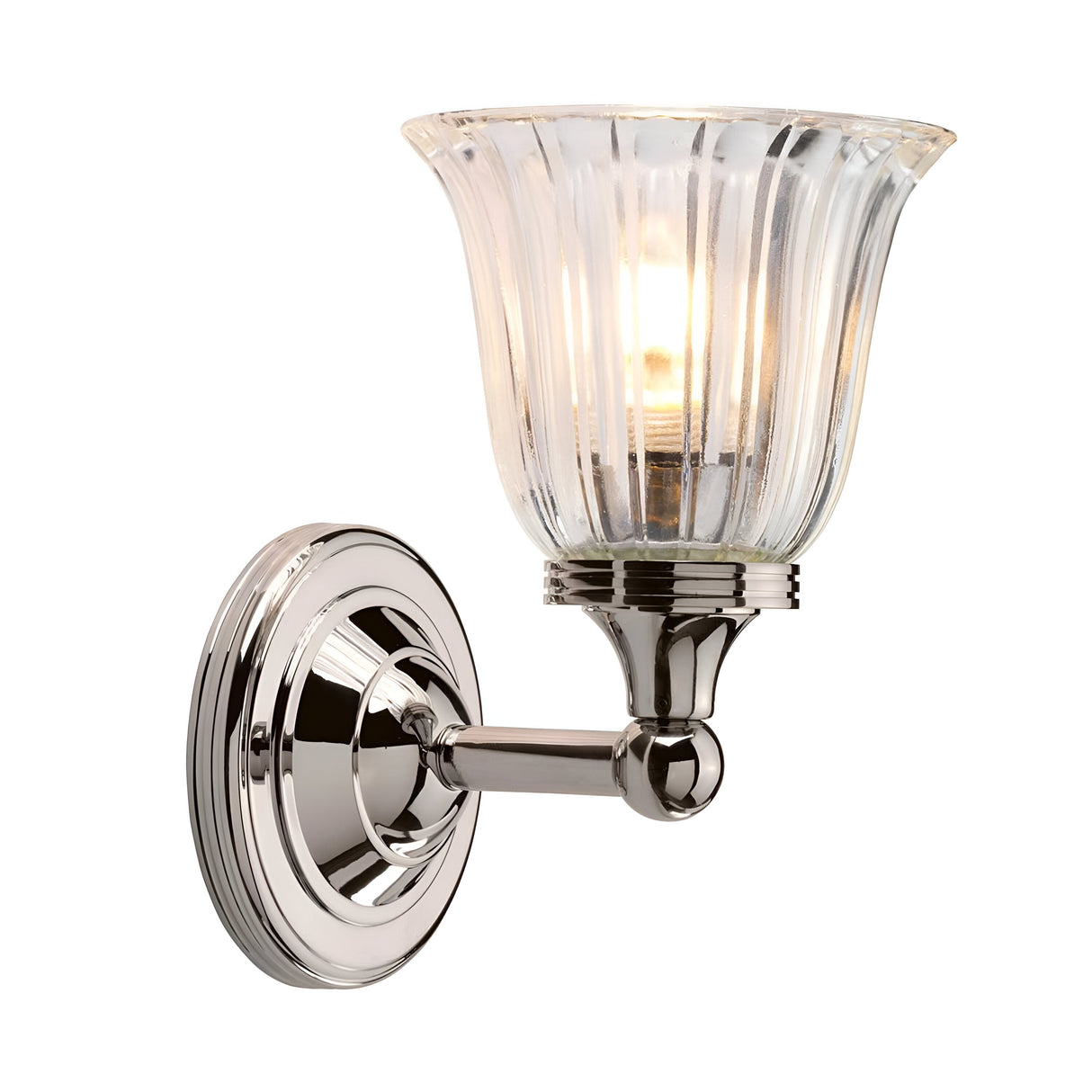 The Austen Wall Light - Polished Nickel is an eye-catching wall-mounted sconce featuring a polished nickel base and a fluted translucent glass shade. Its visible bulb casts a warm glow, making it ideal for indoor decorative and energy-efficient lighting.