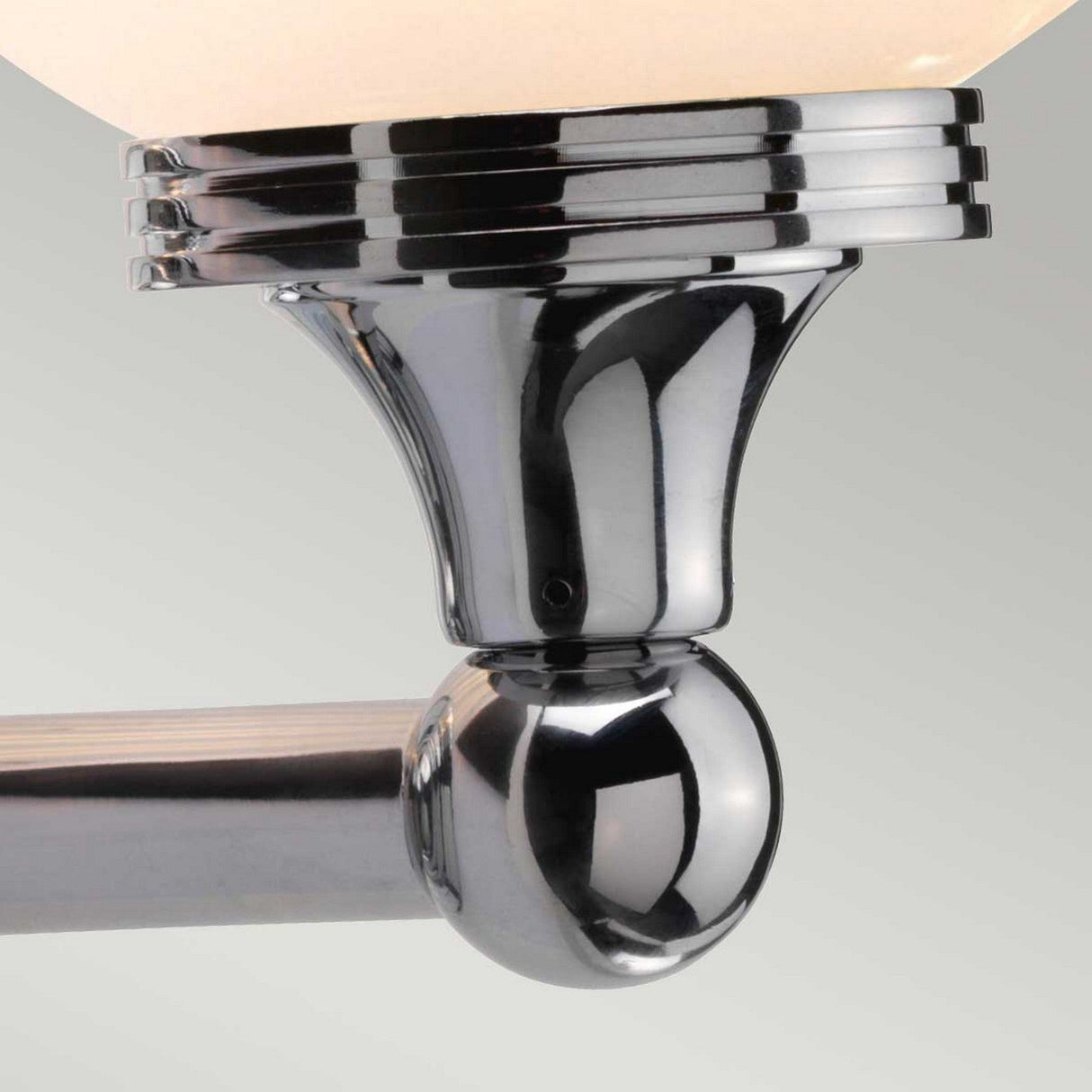 Introducing the Austen-3 Wall Light in polished chrome, featuring a sleek spherical base complemented by a series of thin horizontal rings. This fixture boasts a frosted glass globe that embodies clean sophistication, enhanced by energy-efficient LED light elements for a touch of modern elegance.