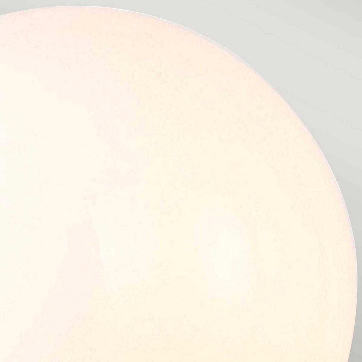 A close-up of the Austen-3 Wall Light in Polished Chrome, set against a light gray background that accentuates its minimalist design. The off-white, round fixture dominates the frame, with gentle lighting emphasizing its sleek and smooth finish, reminiscent of an energy-efficient LED light.