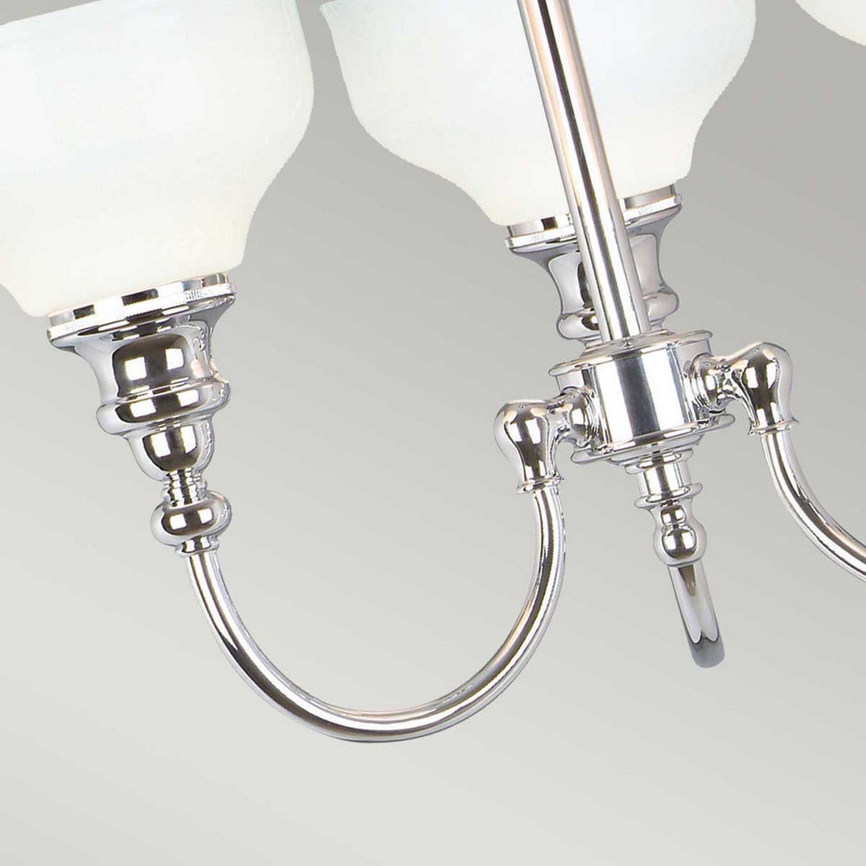 Close-up of the Cheadle 3 Light Semi Flush, featuring polished chrome with curved arms and opal glass shades. The intricate metalwork and glossy finish create a modern, elegant look akin to a chandelier.