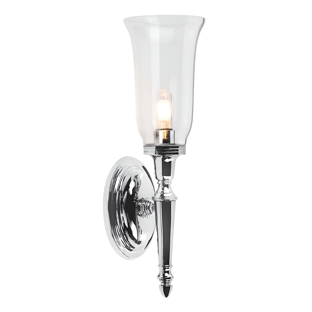 The Dryden-2 Wall Light - Polished Chrome is a sleek and elegant fixture showcasing its polished chrome design with a clear glass shade. It features an LED G9 lamp and mounts on a circular base, providing beautiful illumination against its plain white backdrop in any room.