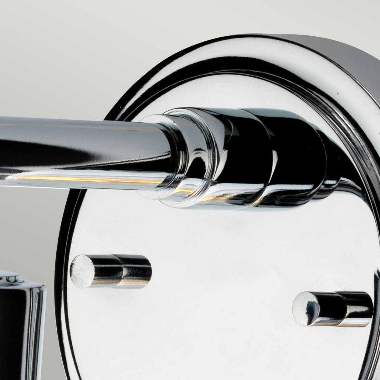 Close-up of a shiny, polished chrome finish round door handle on a light-colored background. The reflective surface showcases the metallic sheen and sleek design, echoing the elegance of the Morvah 1 Light Outdoor Wall Light in polished chrome.