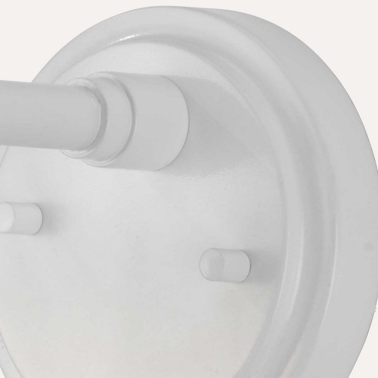 Close-up of the Morvah 1 Light Outdoor Wall Light in white, showcasing its round metallic base with a cylindrical bar. Set against a light gray background, it features two small protruding ends and boasts an IP44 rating for enhanced durability. This minimalist design effortlessly complements any space.