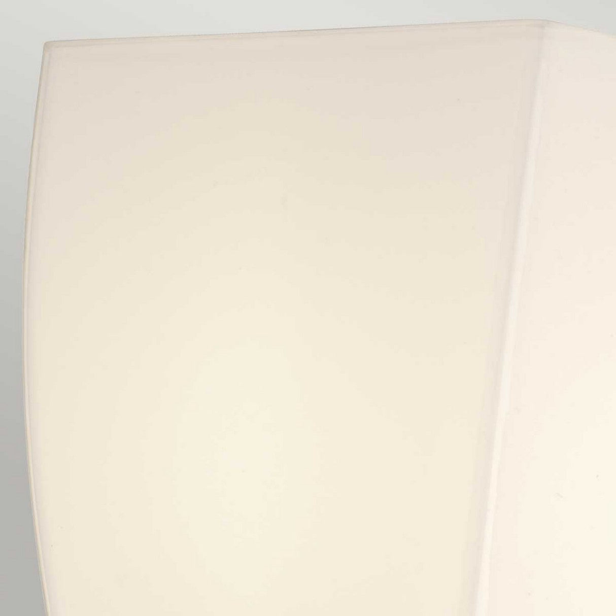 Close-up of the Shirebrook 1 Light Wall Light in polished chrome, featuring a minimalistic, off-white lampshade with soft lighting. Its smooth surface and chrome accents offer a clean and contemporary appearance, while the IP44 rating ensures it is suitable for damp environments like bathrooms.