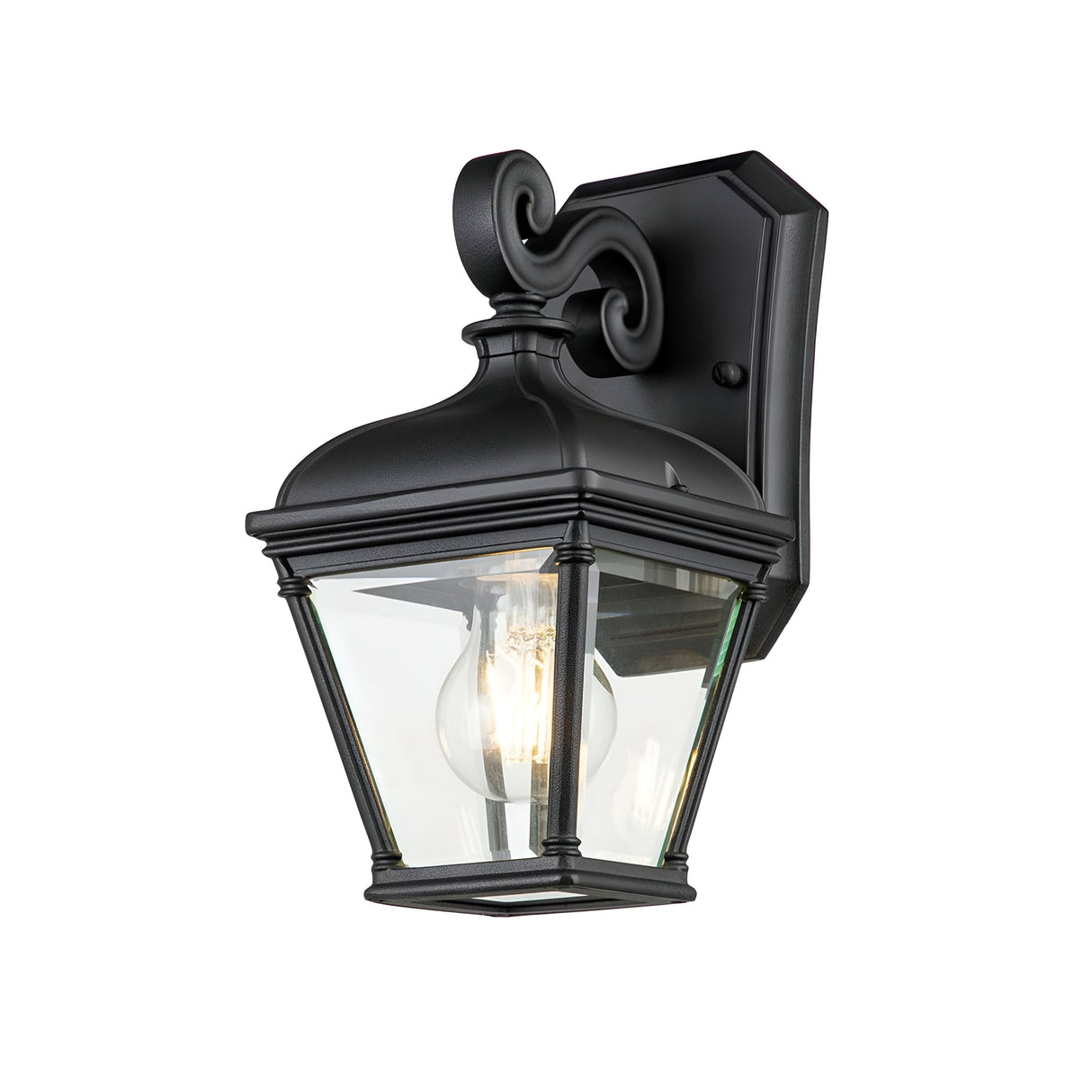 The Bayview 1 Light Outdoor Small Wall Lantern - Black is an outdoor wall lantern with a traditional design. It features clear glass panels and an exposed light bulb, mounted on a decorative scrollwork bracket. Its IP44 rating ensures durability for all your outdoor lighting needs.
