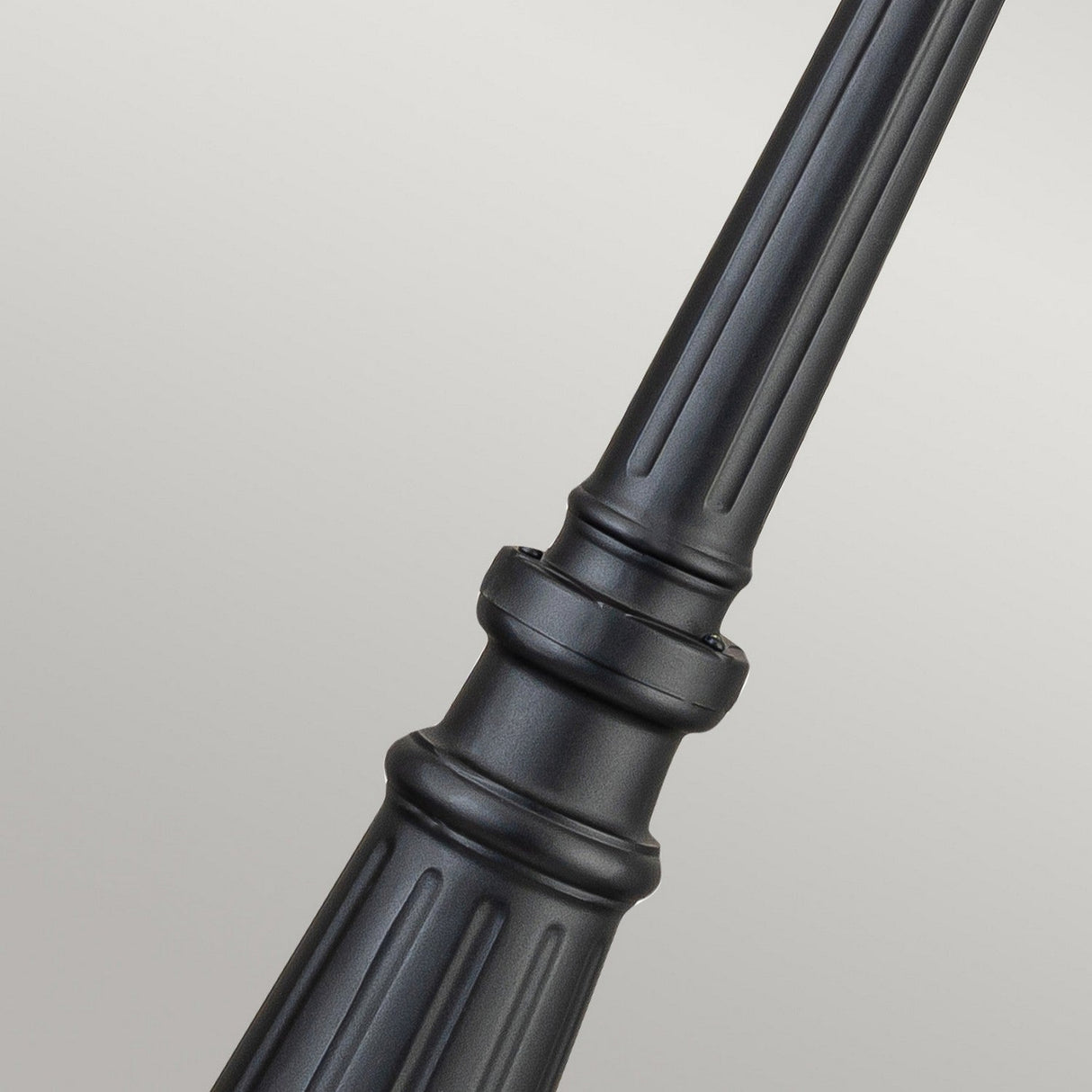 Close-up of the Bayview 1 Light Lamp Post in black, featuring a modern and minimalist design with vertical grooves. Set against a neutral background, this outdoor lighting piece showcases smooth lines and a robust build.