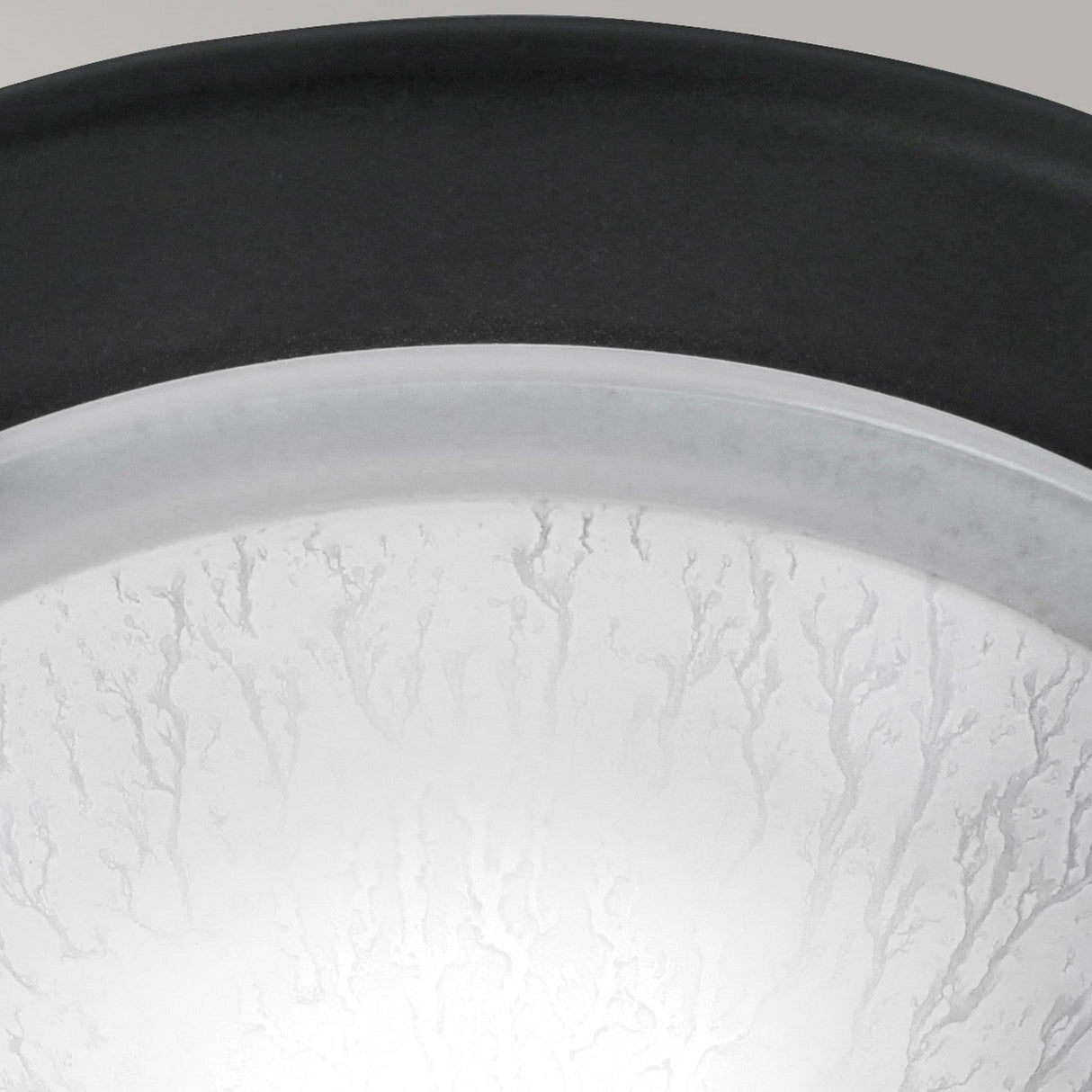 Close-up of the Berwick Flush Light - Black, featuring a frosted glass surface with a textured design and black rim, ideal for modern interiors. It provides a soft, diffused glow and comes with options for a customizable finish.