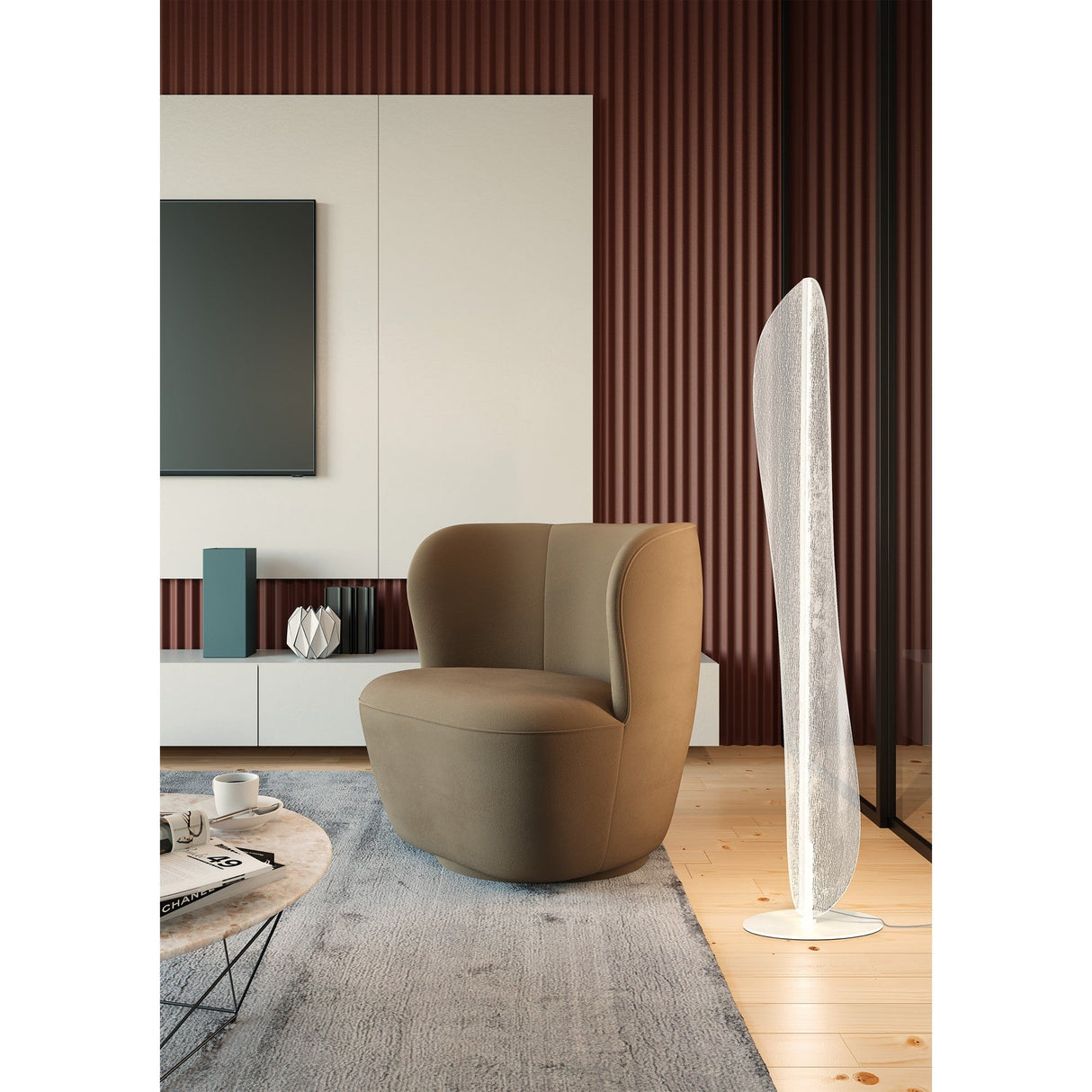 A modern living room with a curved brown armchair, the Bianca LED Floor Lamp 30W 3000K - White, and a low white cabinet set against ribbed brown and white walls. A round gray rug lies on the wooden floor.