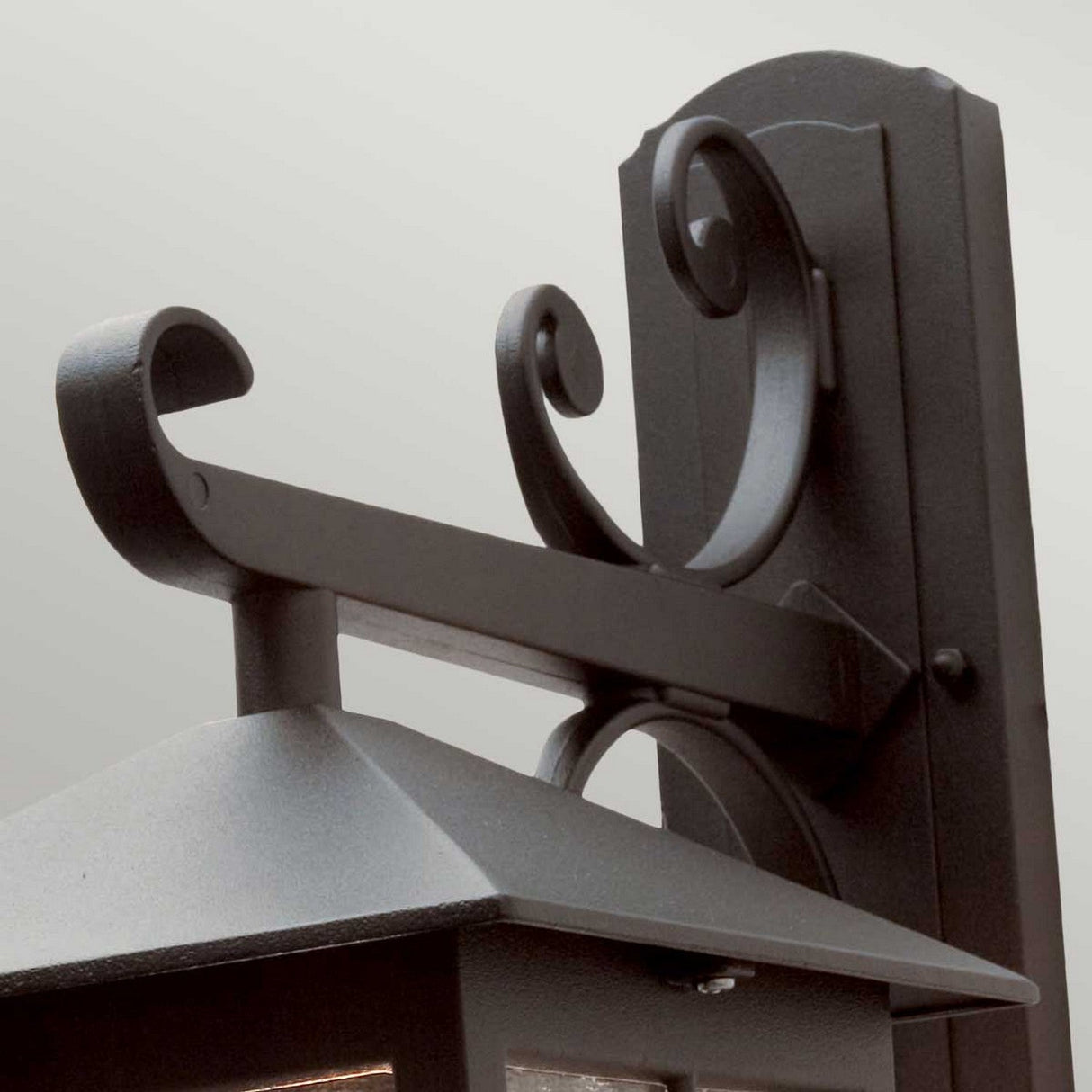 Close-up view of the Winchester-2 1 Light Outdoor Wall Down Light in black, featuring decorative scrollwork details on the bracket and a pyramidal top, embodying vintage lighting charm.