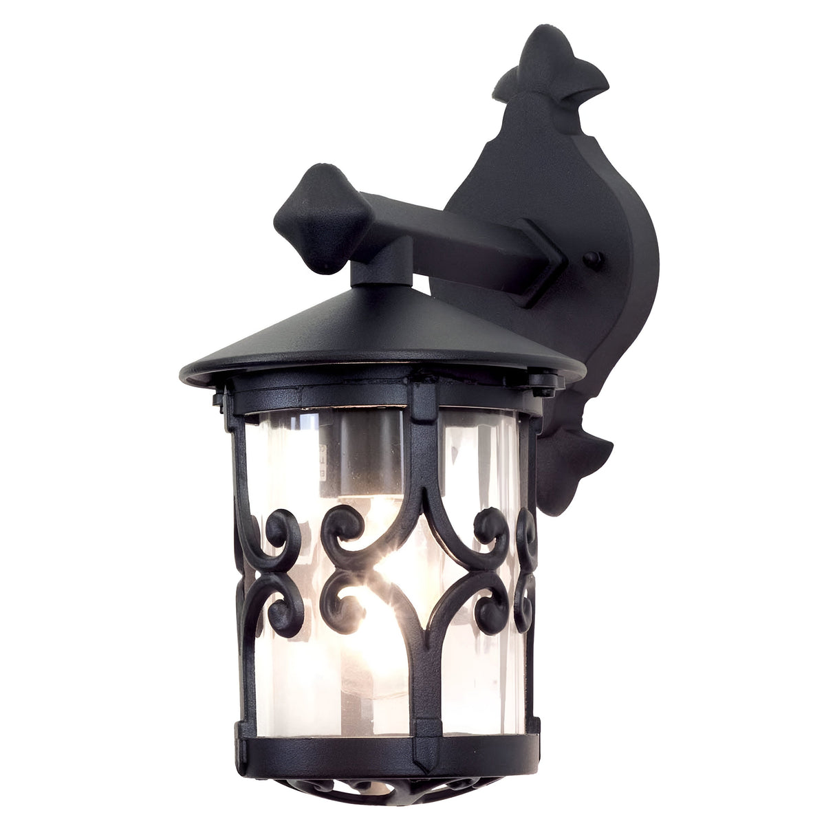 The Hereford Outdoor Wall Down Lantern - Black is a decorative black lantern-style fixture with a timeless design, featuring clear glass panels and intricate scrollwork. Made from die-cast aluminum, it is mounted on a black wall bracket and topped with a pointed finial.