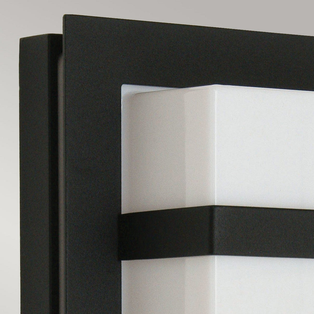 A close-up of the Boden Outdoor 1 Light Wall Light highlights its sleek, rectangular design, featuring a black metal frame encasing a frosted glass diffuser, perfect for contemporary settings.