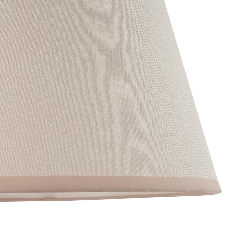 Close-up of the Endon Brockbury 40cm tapered lamp shade in vintage white cotton mix with an almond white contrasting taped edge.