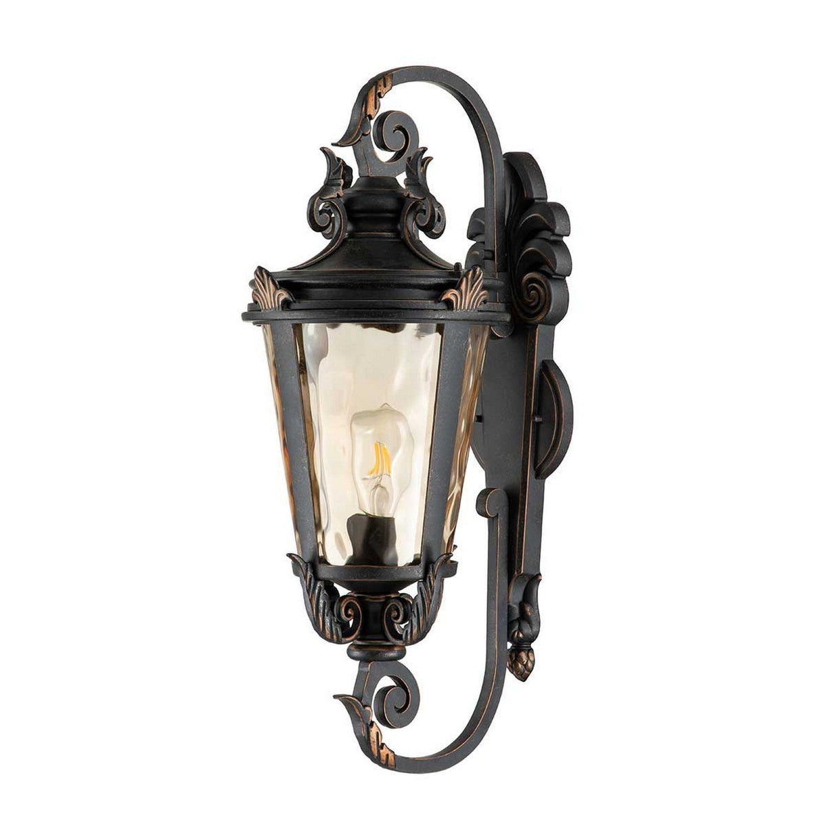 The Baltimore 1 Light Outdoor Large Wall Lantern in weathered bronze features an ornate metal design with amber-tinted glass that houses a light bulb. This outdoor wall light showcases intricate scrollwork and offers a classic, vintage style.