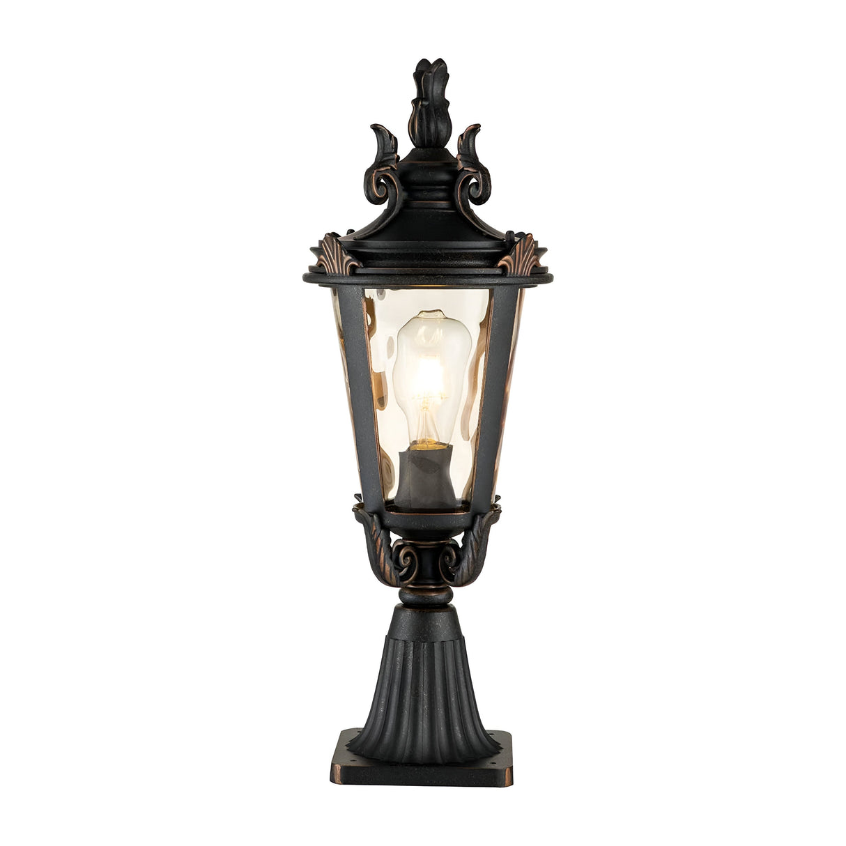 The Baltimore 1 Light Medium Pedestal Lantern boasts a vintage-style design with a weathered bronze finish and intricate detailing. It features amber-tinted glass that highlights the glowing light bulb and is elegantly mounted on a decorative base to add charm to any setting.