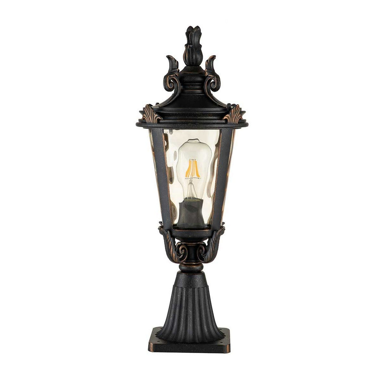 The Baltimore 1 Light Medium Pedestal Lantern, crafted with a vintage design, showcases a tapered, amber-tinted glass enclosure and an ornate black metal frame. It is elegantly mounted on a weathered bronze pedestal and houses a single visible light bulb.